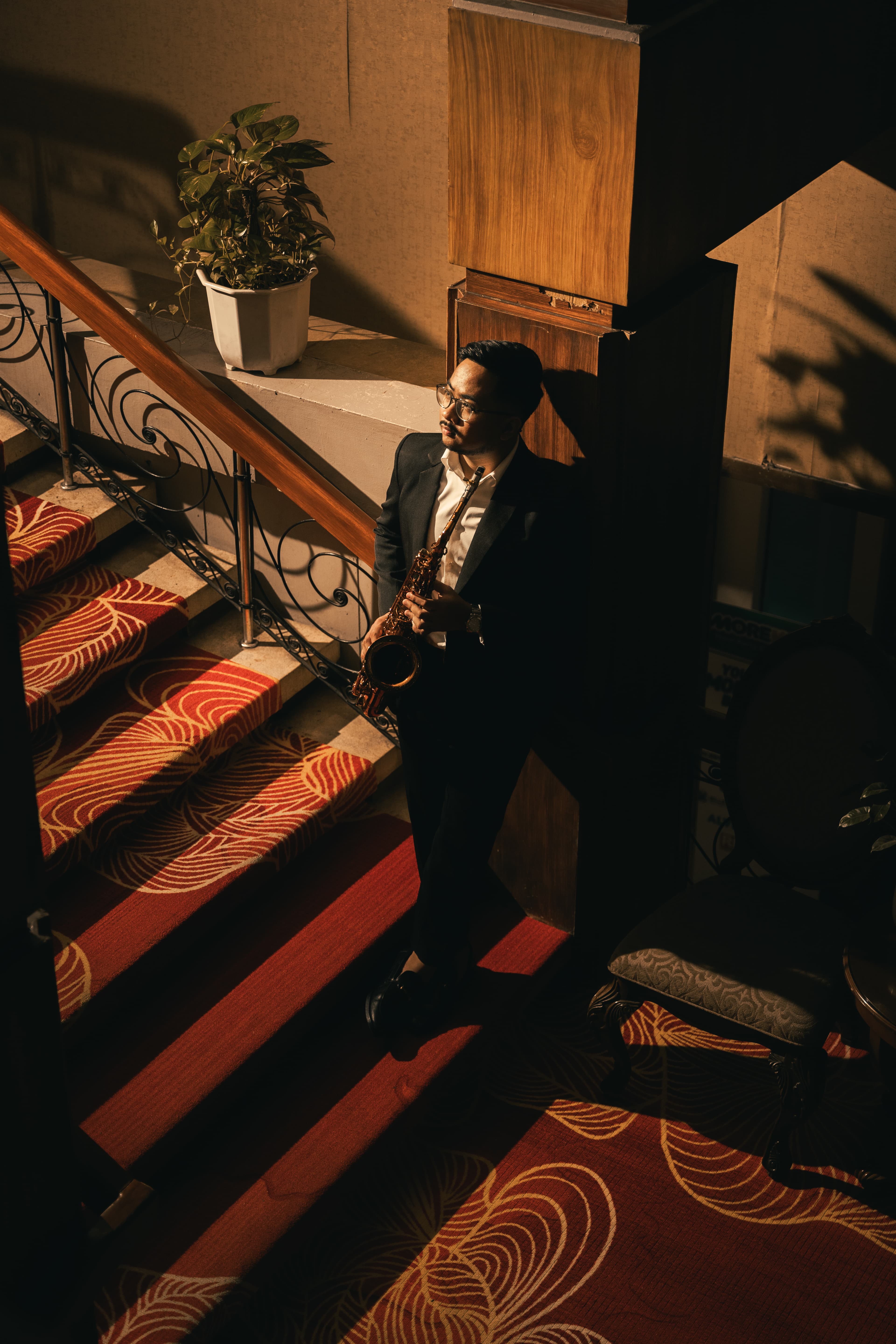 Noy Cajilig seated in a hotel balcony lounge with warm lighting